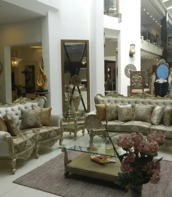 Luxury royal sofa set with cream velvet button-tufted backrest and gold hand-carved rosewood frame available at Haq Bahoo Furniture sofa store.