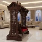 Handmade rosewood swing for home with see-through carved pillars and dark brown chocolate finish in a two-seater design