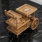 Handcrafted rolling cart with wheels featuring 3 tiers, decorative inlay, bottle holders, and wooden handle by HAQ BAHOO Furniture.